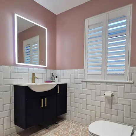Diagonal herringbone white brick tiles in pink themed bathroom