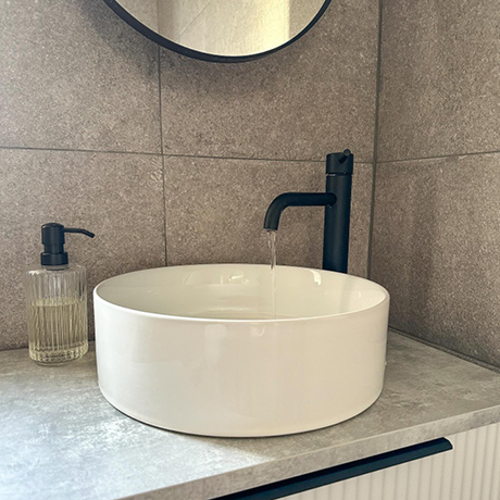 Mottled grey sink splashback in bathroom
