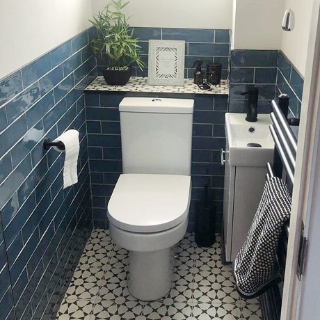 Half tiled blue brick small bathroom toilet