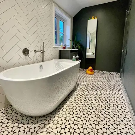 Black and white patterned bathroom floor and herringbone wall