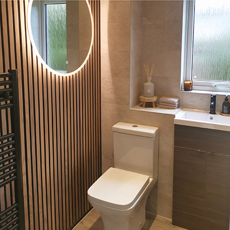 Modern bathroom with wood panelling and Nature Bone tiled on the wall