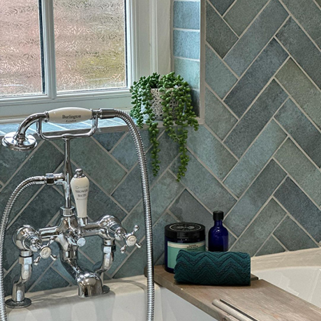 Aqua tiles in a bathroom in a herringbone layout