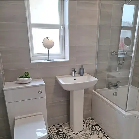 Crisp bathroom with Linear Grey tiled on the walls