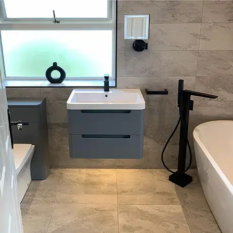 Bathroom tiled in Nature Grey with a floating cabinet