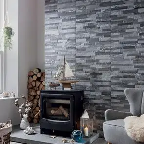 Living room setting with black log burner and fully tiled chimney breast in tiffany grey tiles.