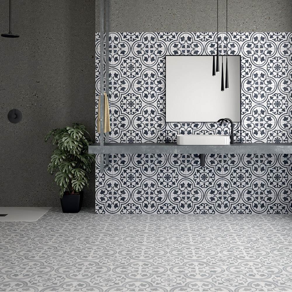 Cuban silver ornate tile in a large open plan bathroom with contrasting cuban white ornate tile being used as a feature wall with wall hung mirror and sinks