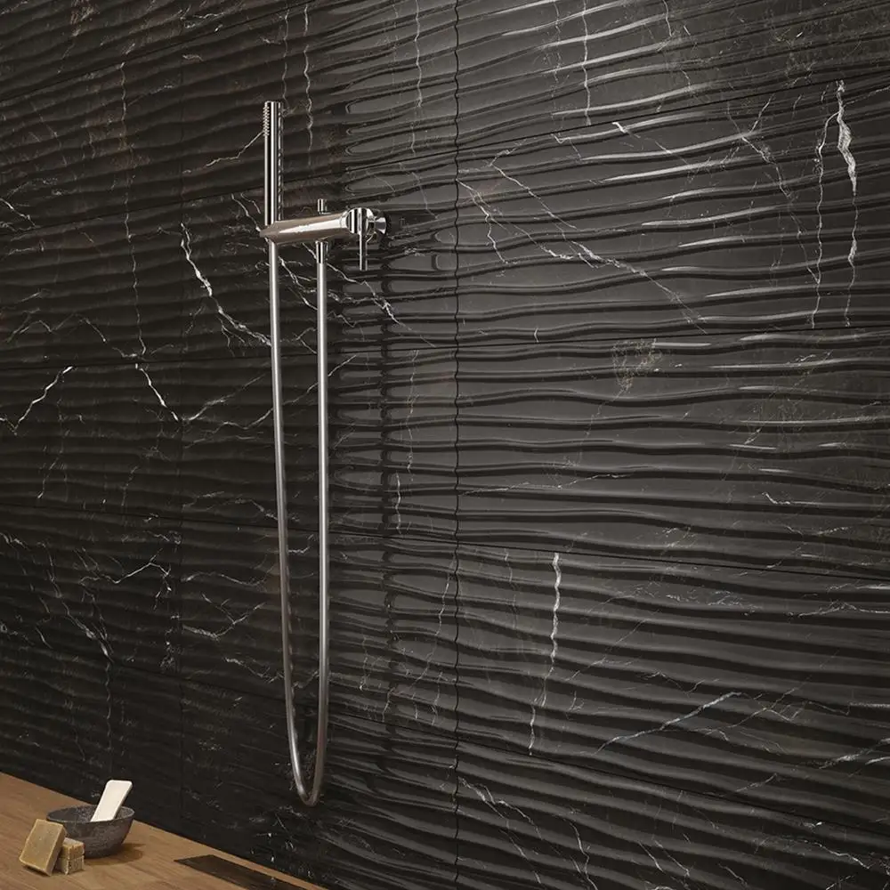 Close up of B&W Star Black Gloss décor mable effect tile on shower wall of bathroom