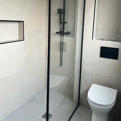 Stone effect tiled shower room and black finishings