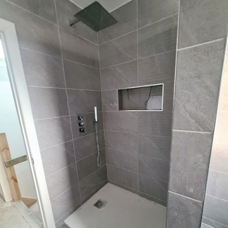 Fully tiled grey walk in shower