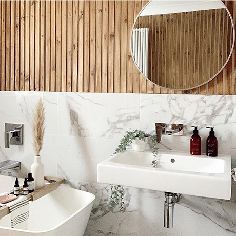 Contemporary bathroom tiled in Lassen Carrara halfway up the wall