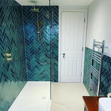 Emerald green herringbone walk in shower area