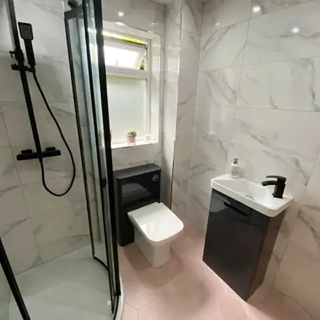 Fully tiled marble bathroom and pink floor