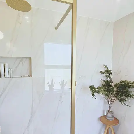 Brass Details in White Marble Shower