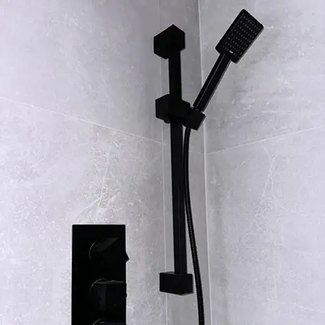 White wall tiles in bathroom with black interior accessories