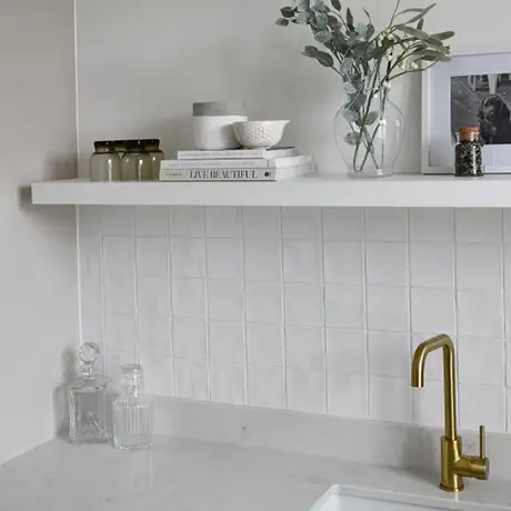 Clean kitchen space with white splashback