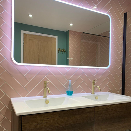 Pink herringbone splashback with his and her sinks