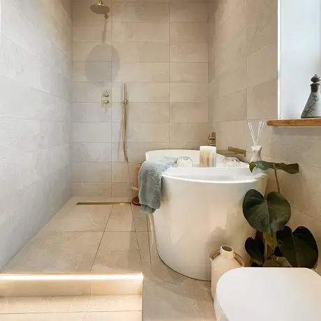 Natural coloured rock beige tiles on walls and floor of bathroom