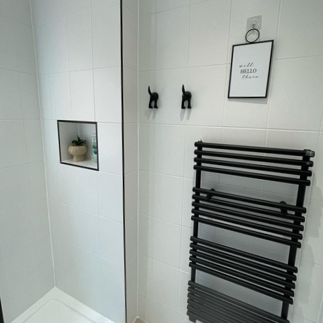 White bathroom with black radiator