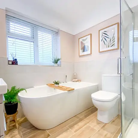 Wood tiled bathroom floor and white bath