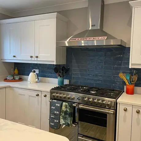 Blue brickbond splashback in grey kitchen