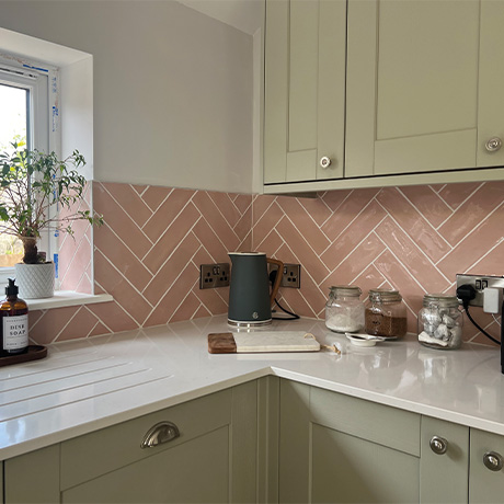 Kitchen with Poitiers Rose Pink splashback and sage cabinetry