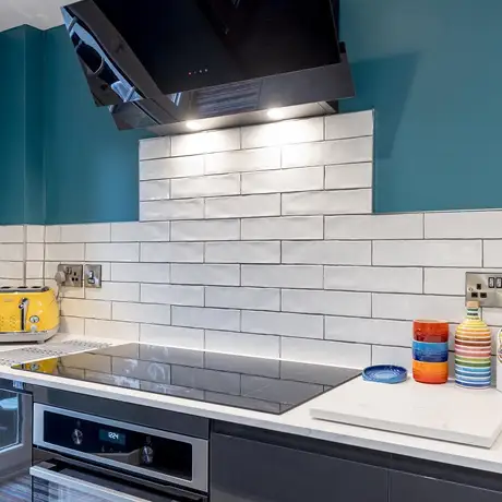 Rustic white tile splashback in a brickbond layout