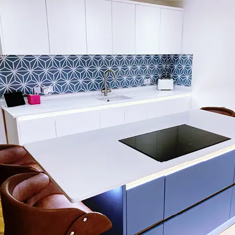 Blue and white hexagon tiles on kitchen wall