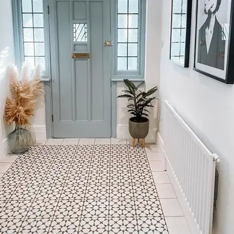 Black and white star floor tiles in hallway