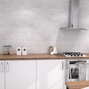 Concrete asphalt grey ceramic tile used as a back splash in a modern kitchen with wooden worktops