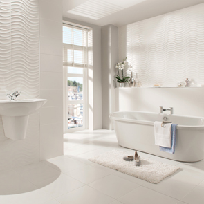 Open plan bathroom with a freestanding bath focal point, fully tiled in the streamline range with matching décor