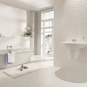 Open plan bath area highlighting a wall mounted sink with the streamline matt wave tile behind.