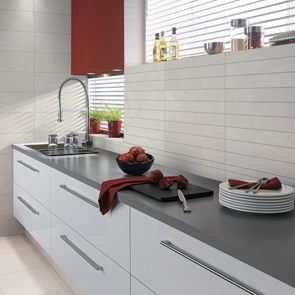 Stone by stone brown floor tile in a open kitchen setting with gloss white cabinets