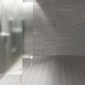 British Stone Grey mosaic being used on the floor in a modern wetroom with matching British Stone grey wall tiles