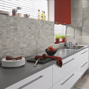 Mosaic style grey wall tiles with grey wall and floor tiles in kitchen.