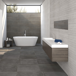 Large grey floor tiles feature along the floor of a luxury bathroom worked together with grey and white textured tiles on the walls
