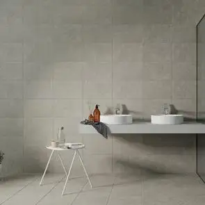 Large open bathroom space with matching quarz tiles on the wall and floor with black edged shower screen and white furnishings