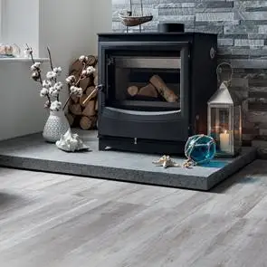 Aspenwood Mink Wood effect floor tile in a traditional floor board pattern with contrasting tiffany Dark Grey feature tile in a living room setting