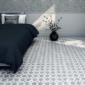 Cuban silver star tile in a modern bedroom, with contrastic black bed & Plant pot