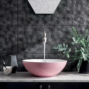 Buxy Antracita black 3D hexagon tile on bathroom feature wall with pink sink and stylish geometric accessories