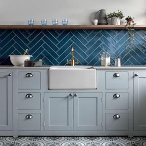 Poitiers azure tiles placed via herringbone on a kitchen wall with pale grey traditional kitchen units