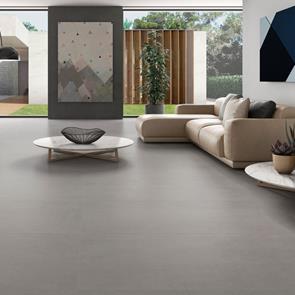 Core concrete 600x600mm tile in a large modern living room with contrasting sofas and modern wall art
