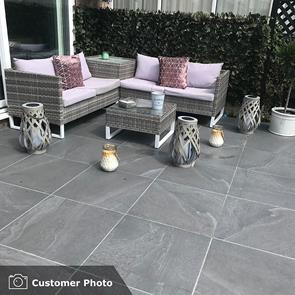 British Stone Antracite (dark grey) outdoor porcelain tile on external garden patio alongside gravelled area