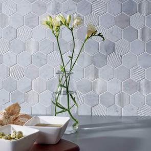 Close up of Fog Stone Hexagon Marble Mosaic on kitchen wall with vase of flowers and food
