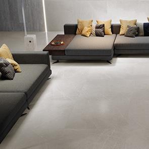 900x450 Inari perla tile in a living room with dark browns and grey furniture