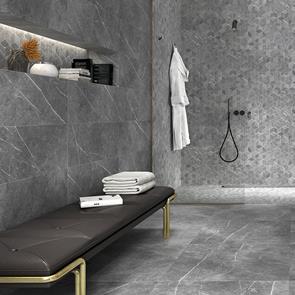 Inari Gris tile being used as a wall and floor tile in a larger open plan bathroom setting with black shower fixings