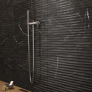 Close up of B&W Star Black Gloss décor mable effect tile on shower wall of bathroom