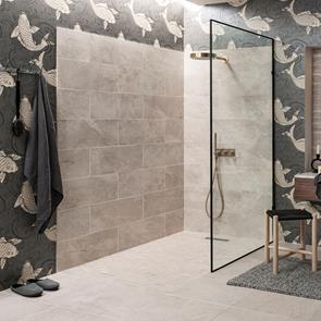Fully tiled bathroom with the nature bone range, with tiled in bath panel and feature strips of the nature bone décor