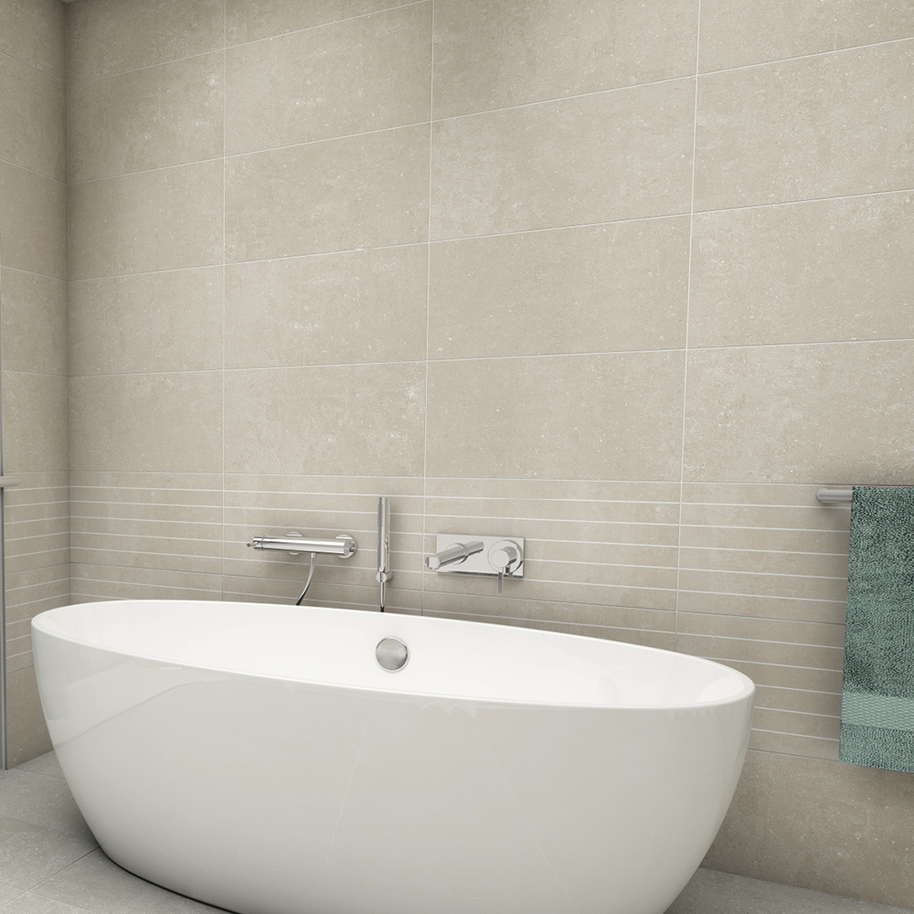 Modern bathroom setting with freestanding bath and the york stone tiles used from half way height and the scored tile as a feature band