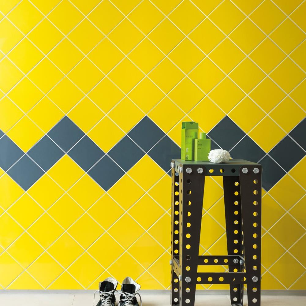 Reflections royal blue and yellow tiles fixed diagonally on bathroom wall