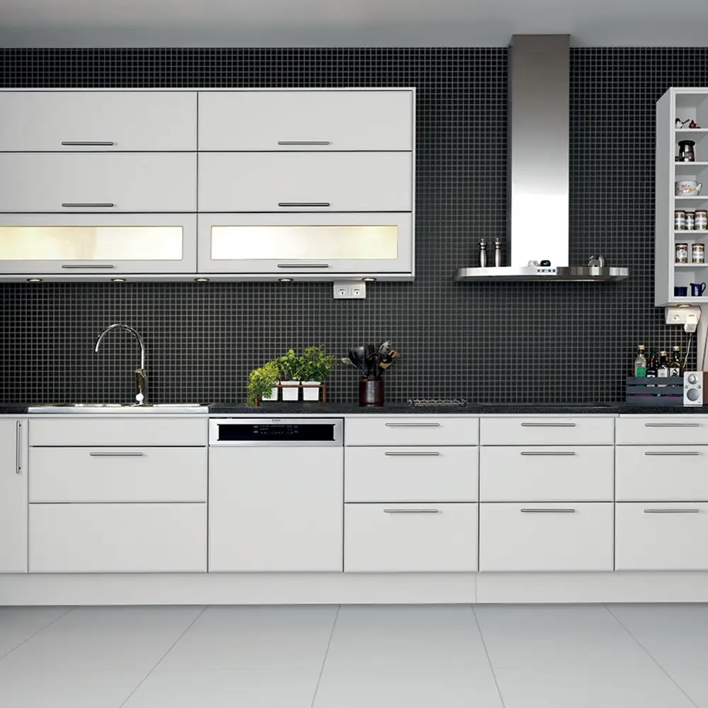 Large kitchen with matt white kitchen units, and fully tiled splashback with step black mosaic tiles.